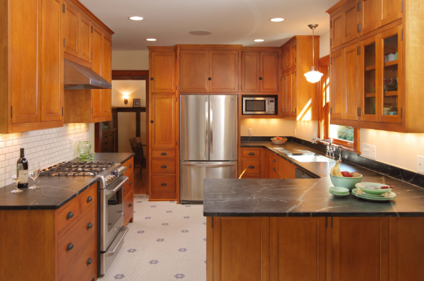 dark countertops in a traditional kitchen with oak cabinets
